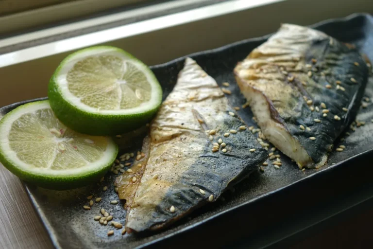 Maquereaux grillés sur un plat avec des rondelles de citron vert